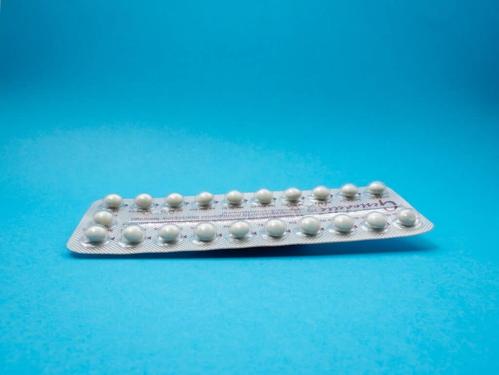 oral contraceptive pill on blue panel